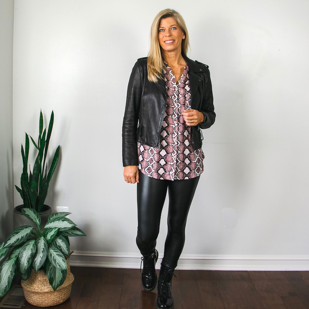 black moto jacket with pink snakeskin blouse and combat boots