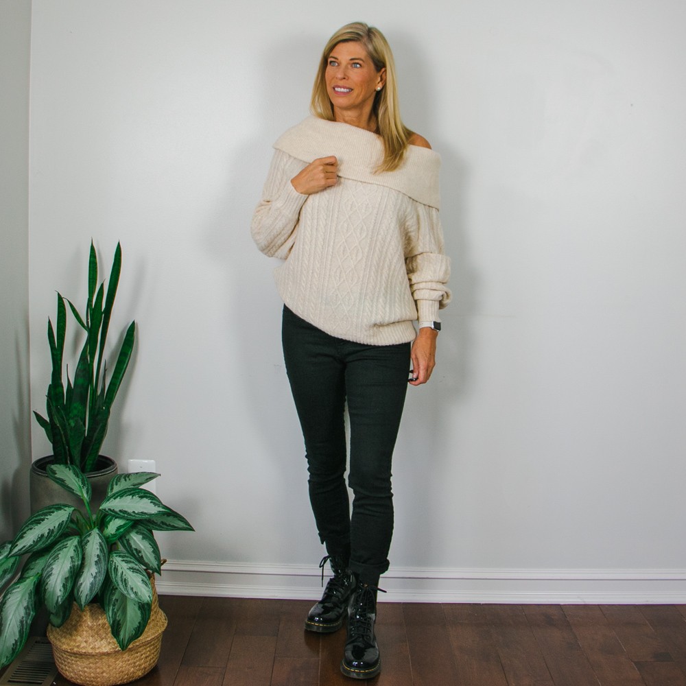 Cream Off-the-shoulder cable sweater with black patent leather Doc Martens.
