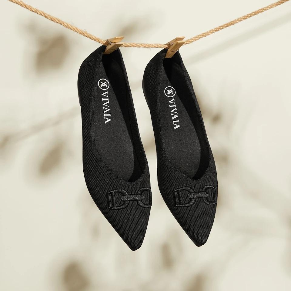 black pointed flats with embroidered buckle detail